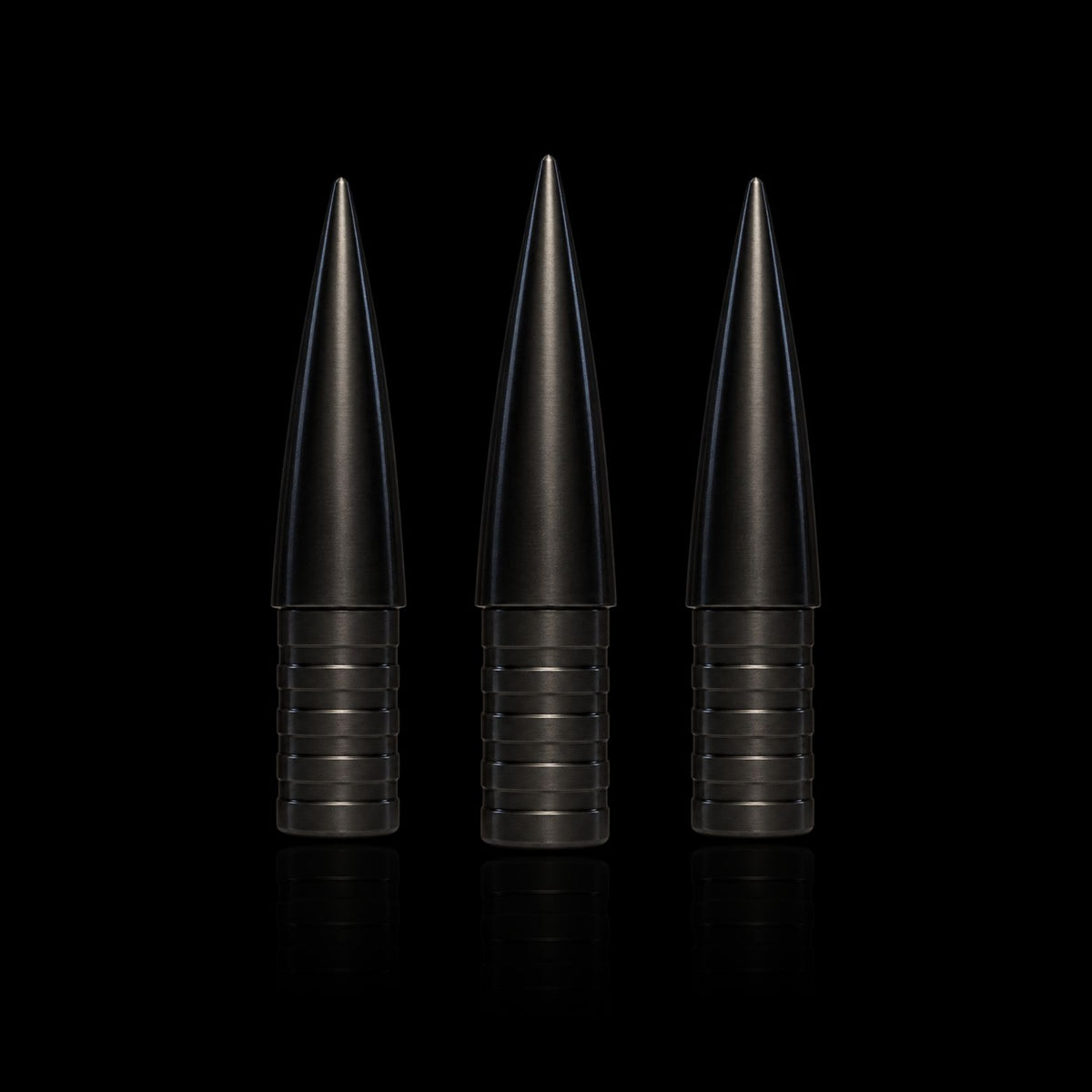 Three Competition Archery Products 3D NockBuster Ballistic arrow points upright on black