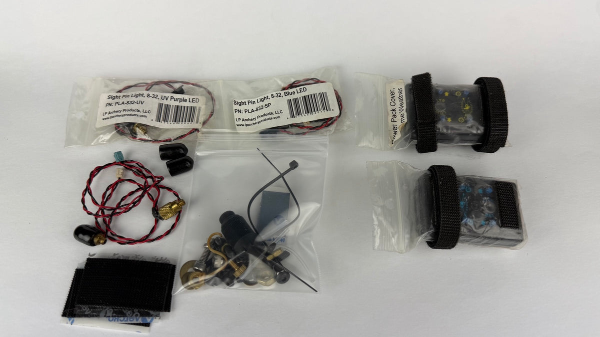 Two LP Archery sight pin light kits with assorted parts and accessories